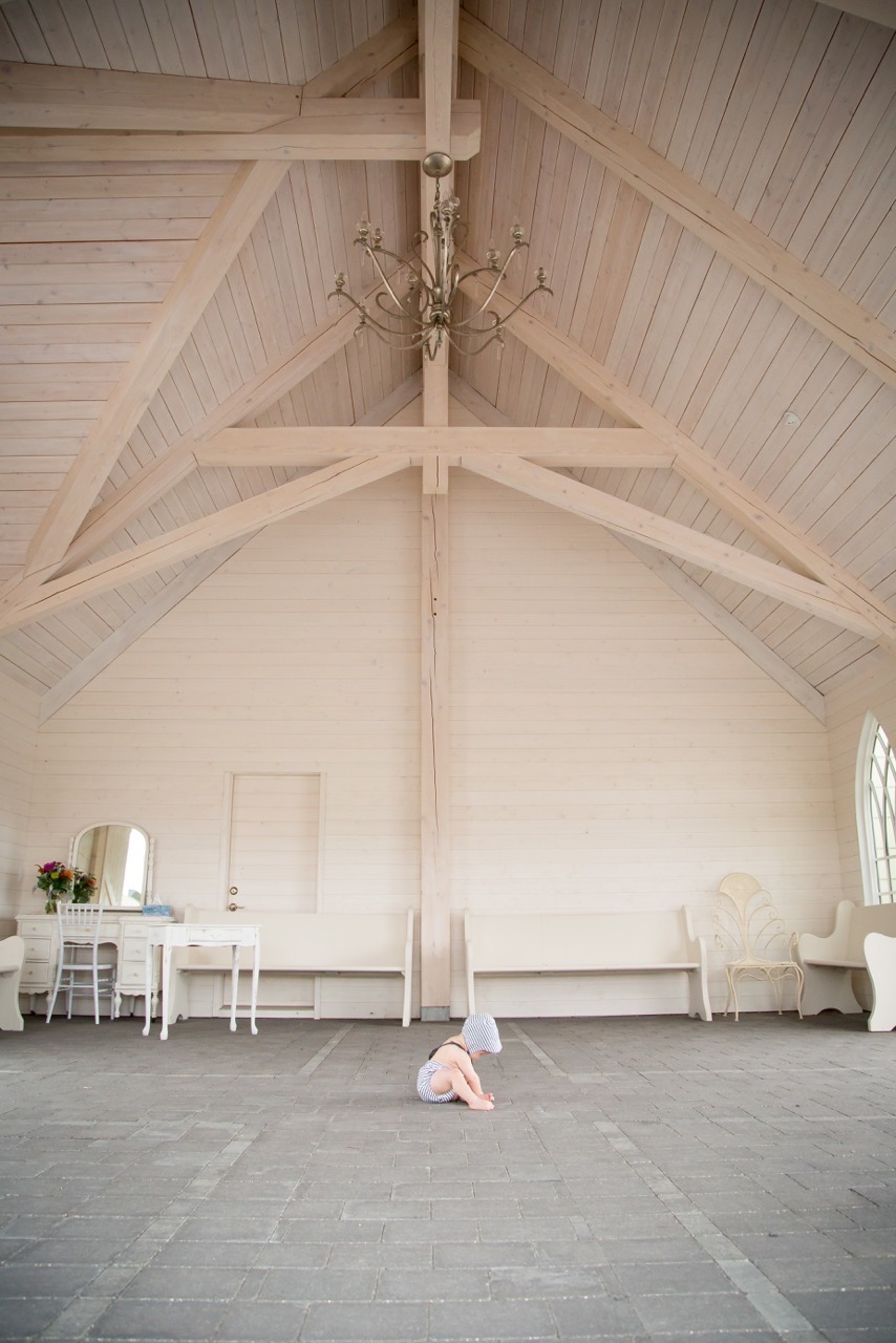 baby playing in a covered space