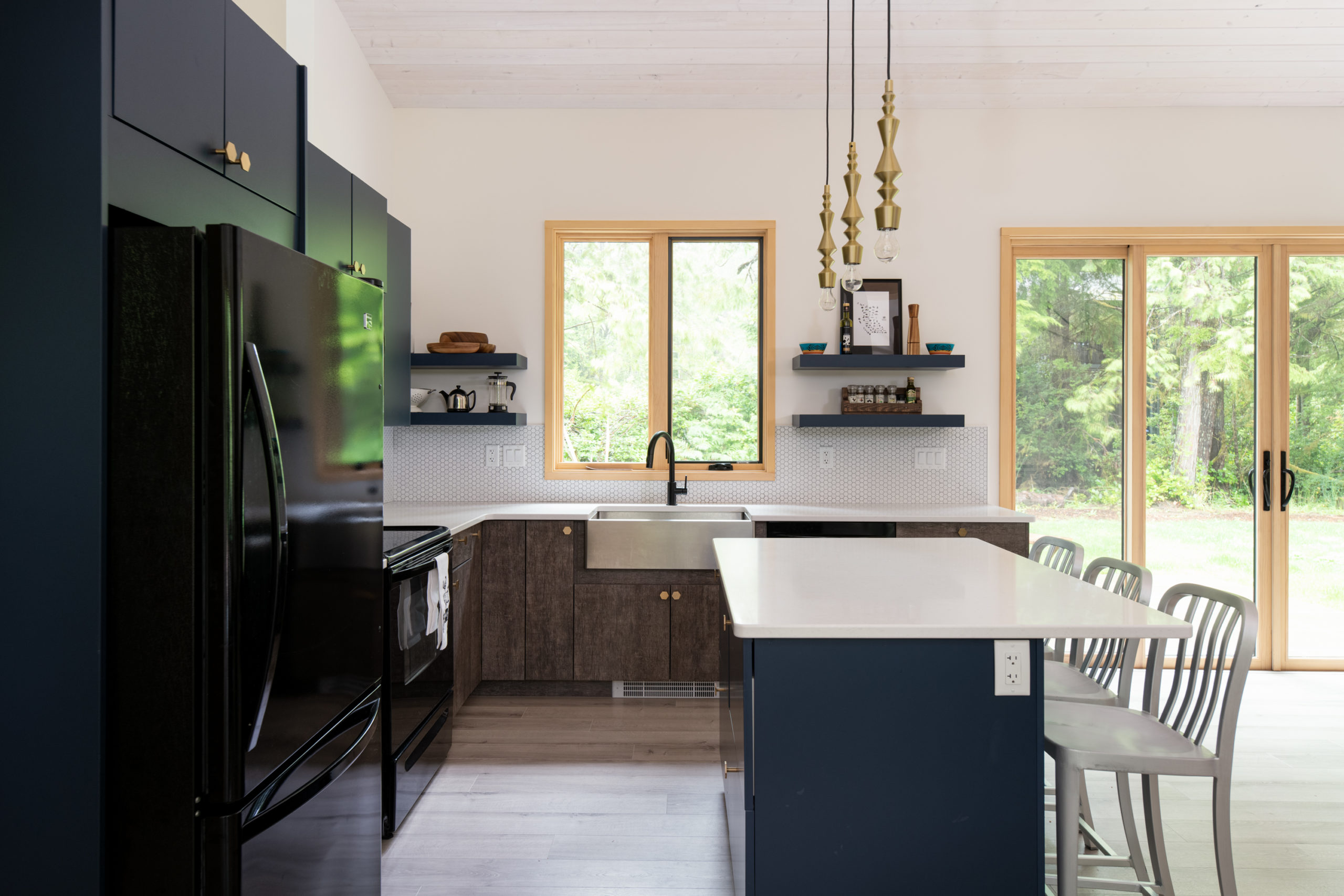 kitchen area of a sleek house with combination of navy blue and white