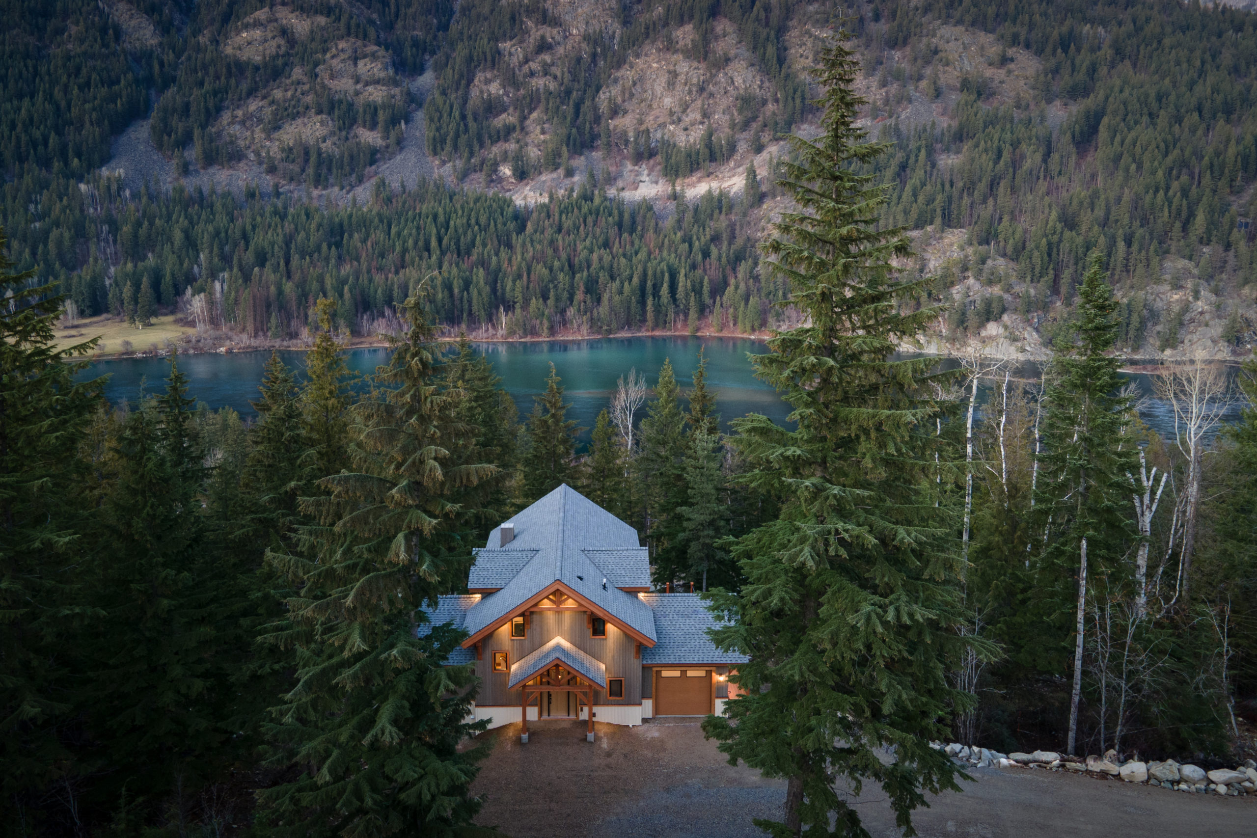 modern house surrounded by tall trees in the mountains