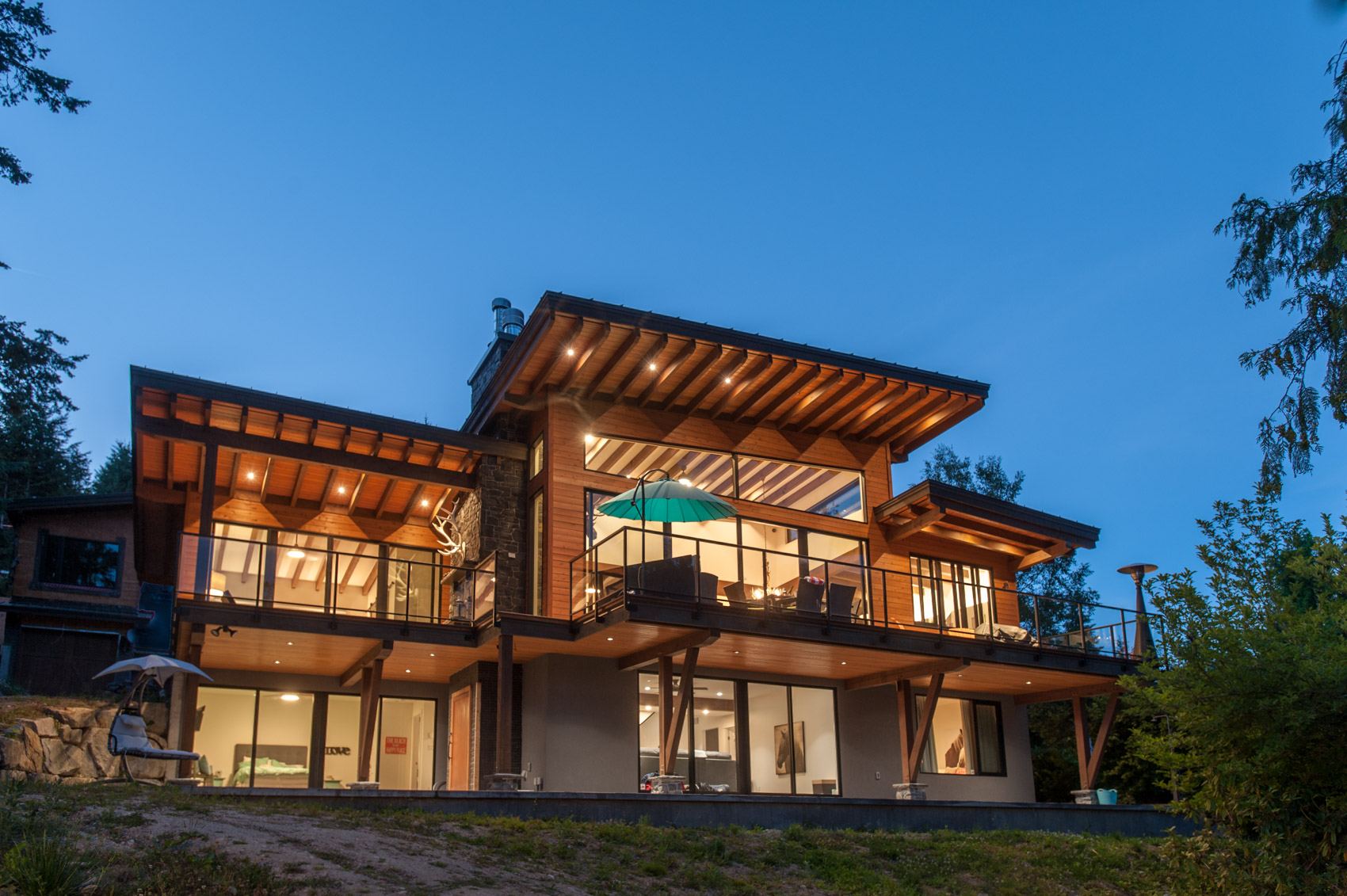 exterior of a modern beach house with lights on