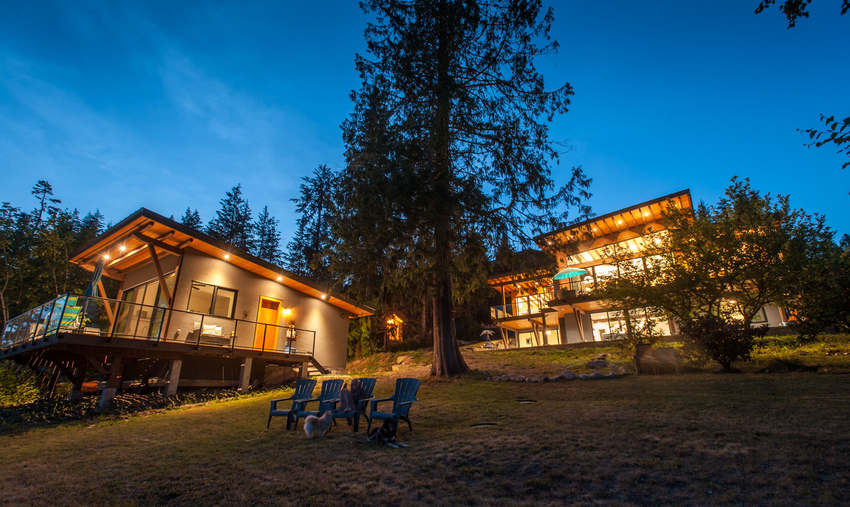 exterior of a modern beach house with lights on