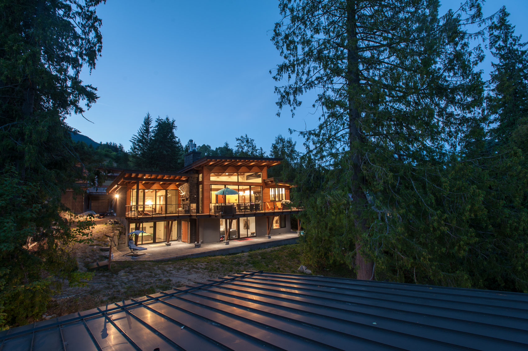 distant view of a modern beach house with lights on