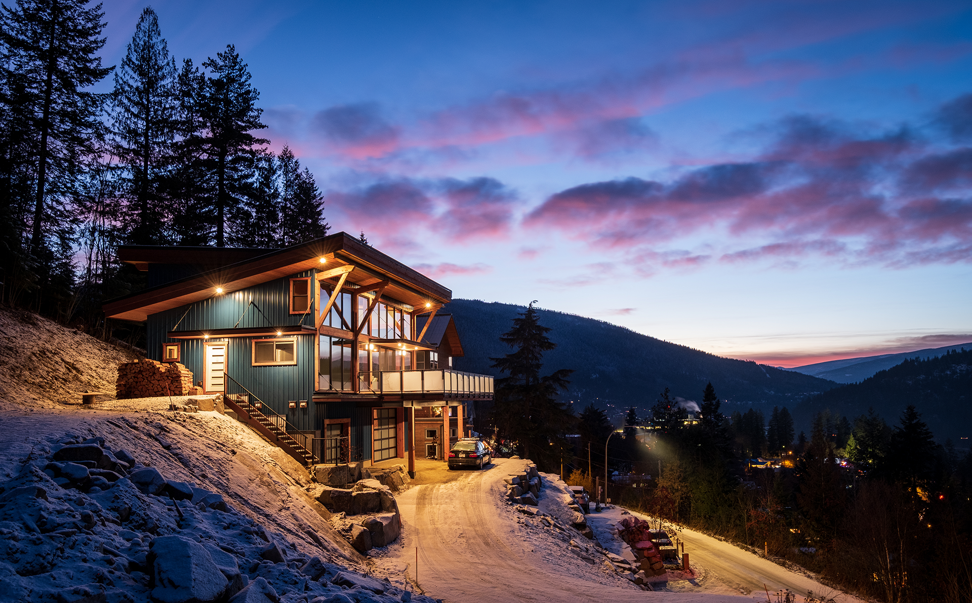 Pacific Northwest house with outdoor lights on at dusk