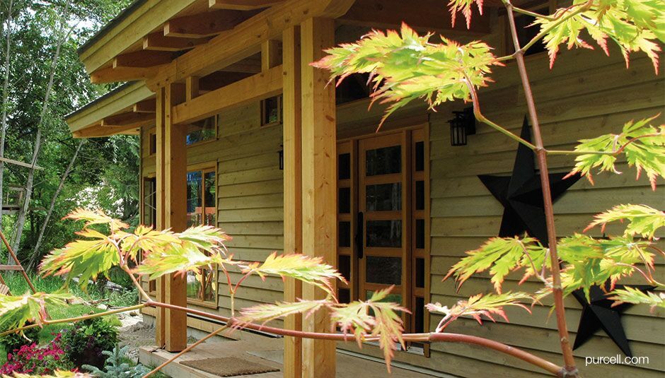 entrance of a house with black metal barn star hanging on the walls